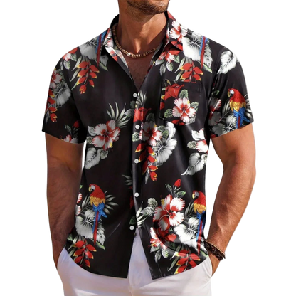 Man wearing a black floral shirt with parrot design on a white background