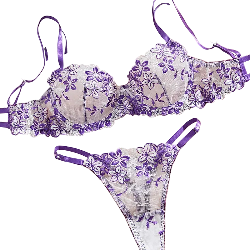 Purple floral lingerie set on a soft pink background with flowers.