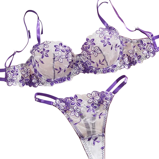Purple floral lingerie set on a soft pink background with flowers.
