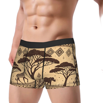 Men's boxer briefs with a beige and brown African safari print featuring acacia trees, antelopes, and a hippo, shown on a male model against a white background.