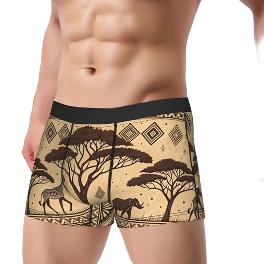Men's boxer briefs with a beige and brown African safari print featuring acacia trees, antelopes, and a hippo, shown on a male model against a white background.