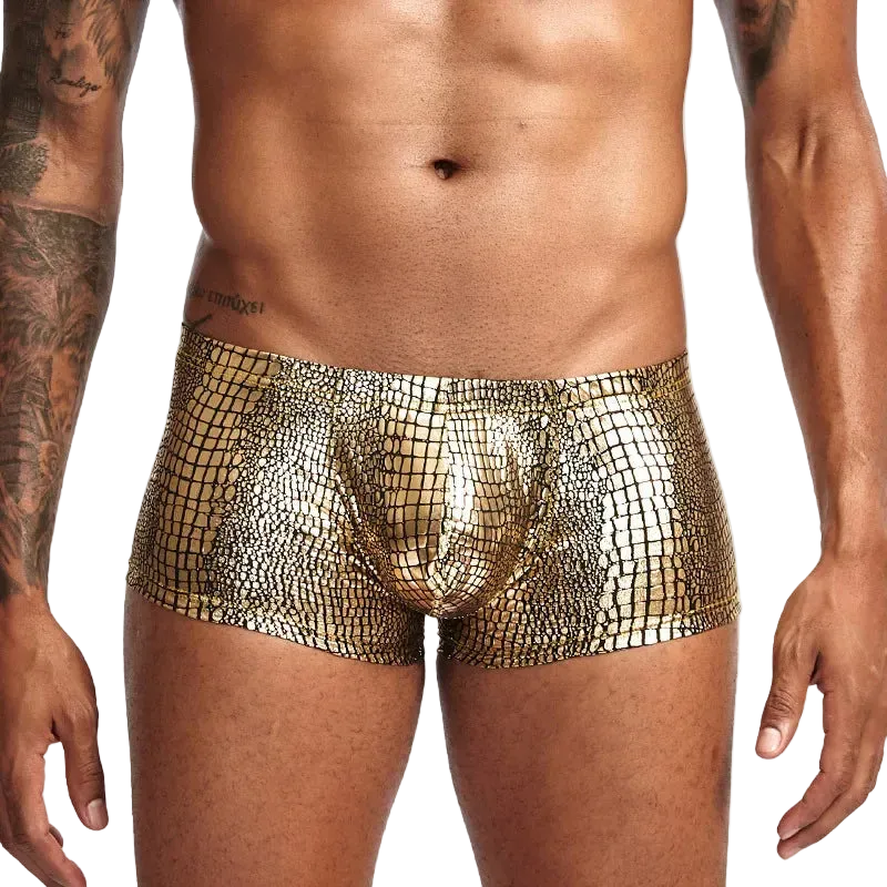 Gold metallic shorts worn by a person on a white background