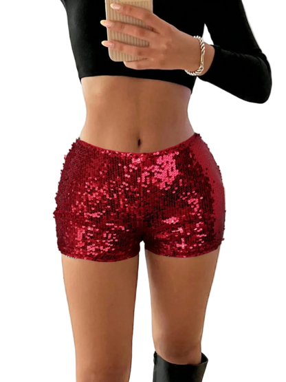 Person wearing red sequin shorts with a blurred indoor background
