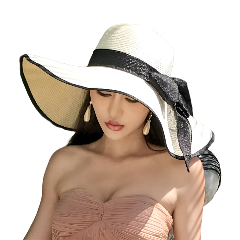 Woman wearing a large sun hat with a black ribbon against a leafy background