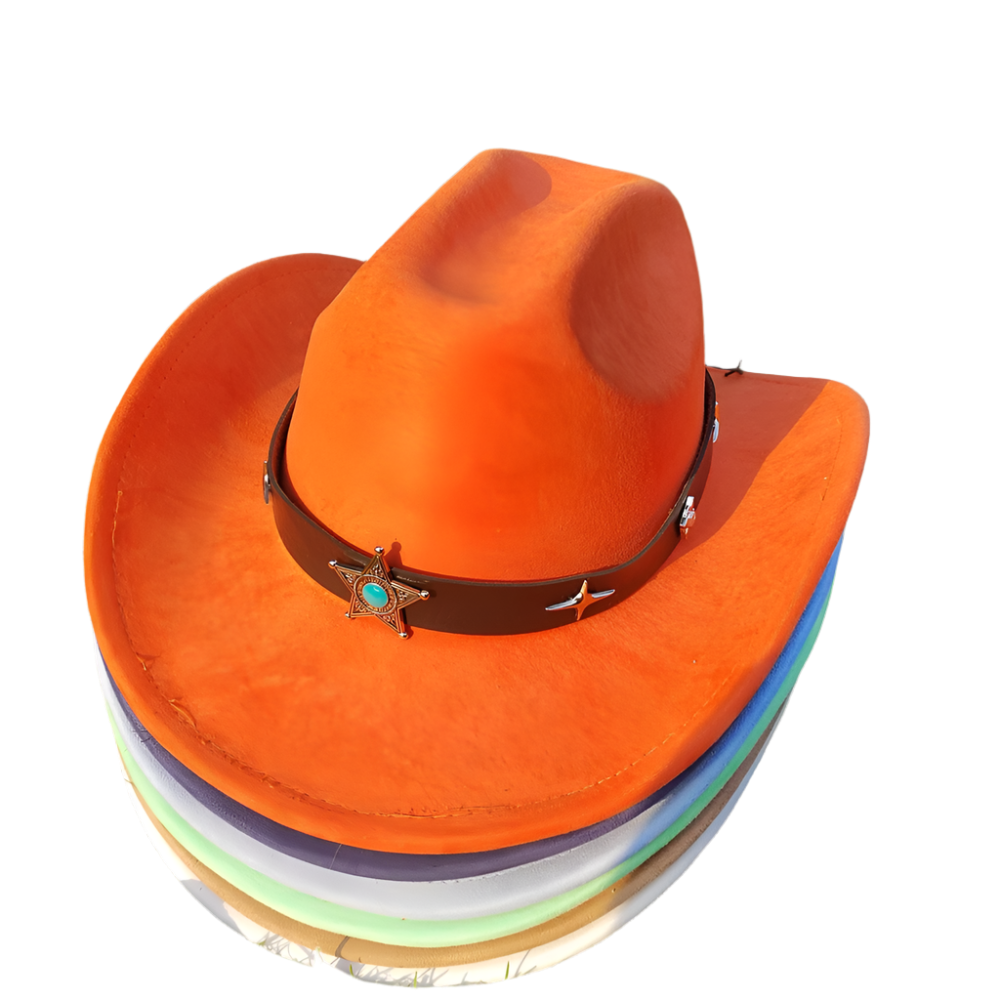 Stack of colorful hats with an orange cowboy hat on top, placed on grass.