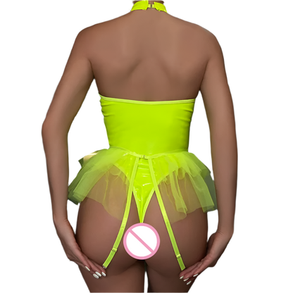 Person wearing a bright green tutu dress with a no entry sign on a dark background
