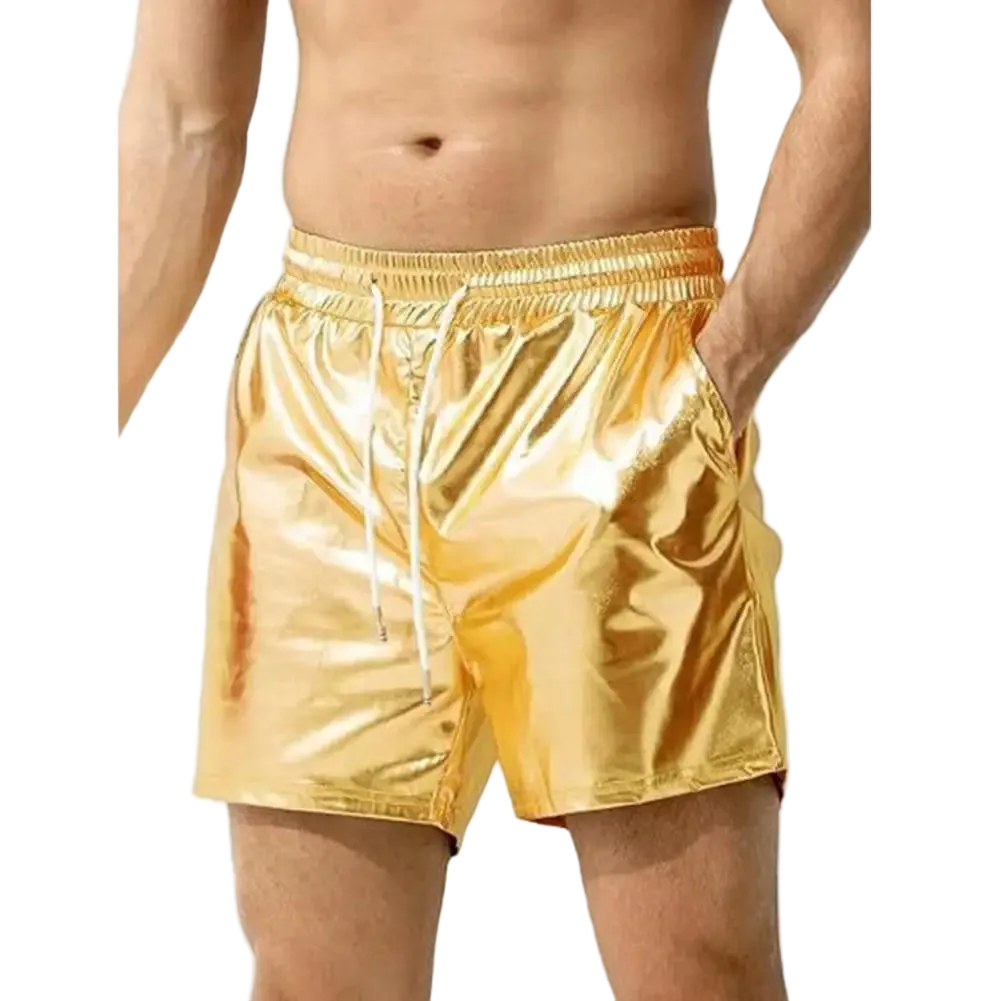 A man wearing shiny metallic gold drawstring shorts against a plain white background.