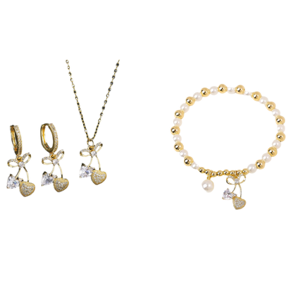 Gold jewelry set with necklace, earrings, and bracelet on a black and white background