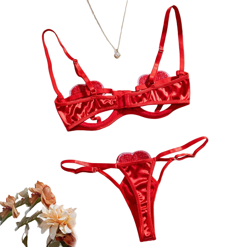Red lingerie set with floral decorations on a light background