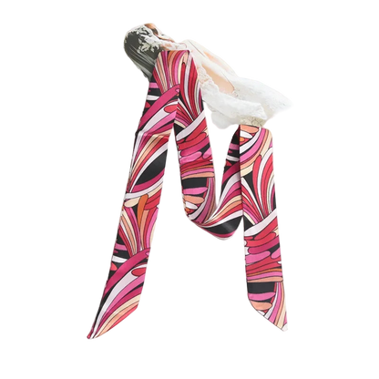 Colorful patterned scarf on a white surface