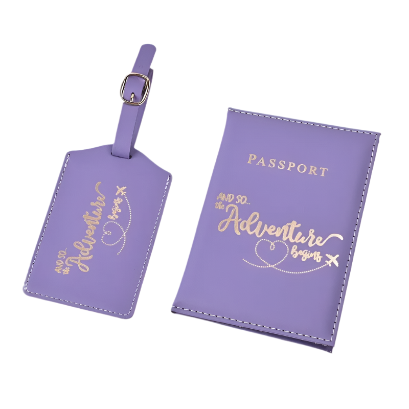 A passport holder and luggage tag set with the phrase "And so the adventure begins" in elegant script. The design is sleek and stylish, perfect for travel.