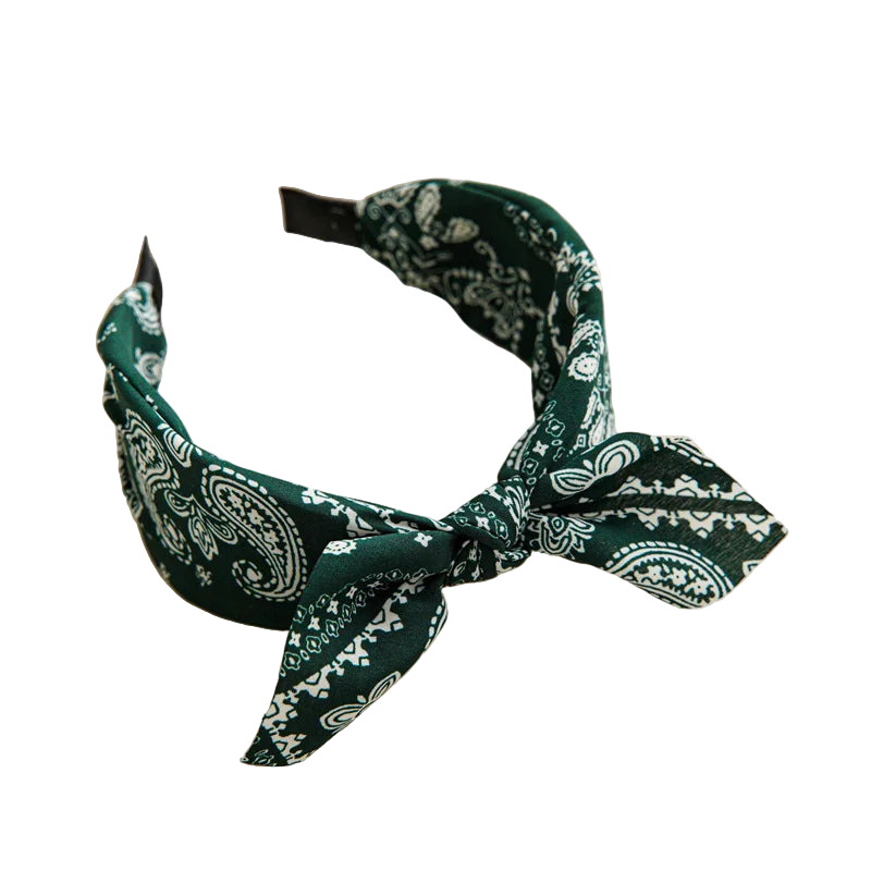 Green bandana headband on a beige tray with a cup and coaster in the background