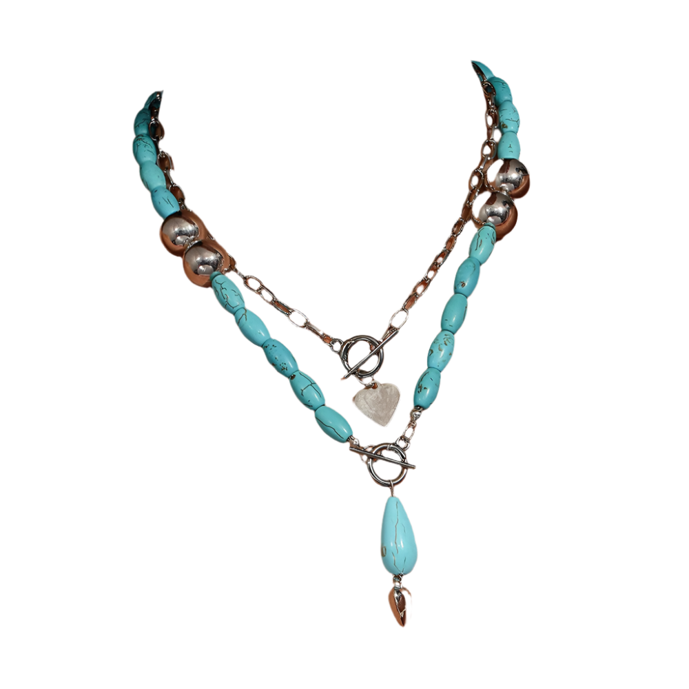 Turquoise beaded necklace with silver chain on a person wearing a white top.