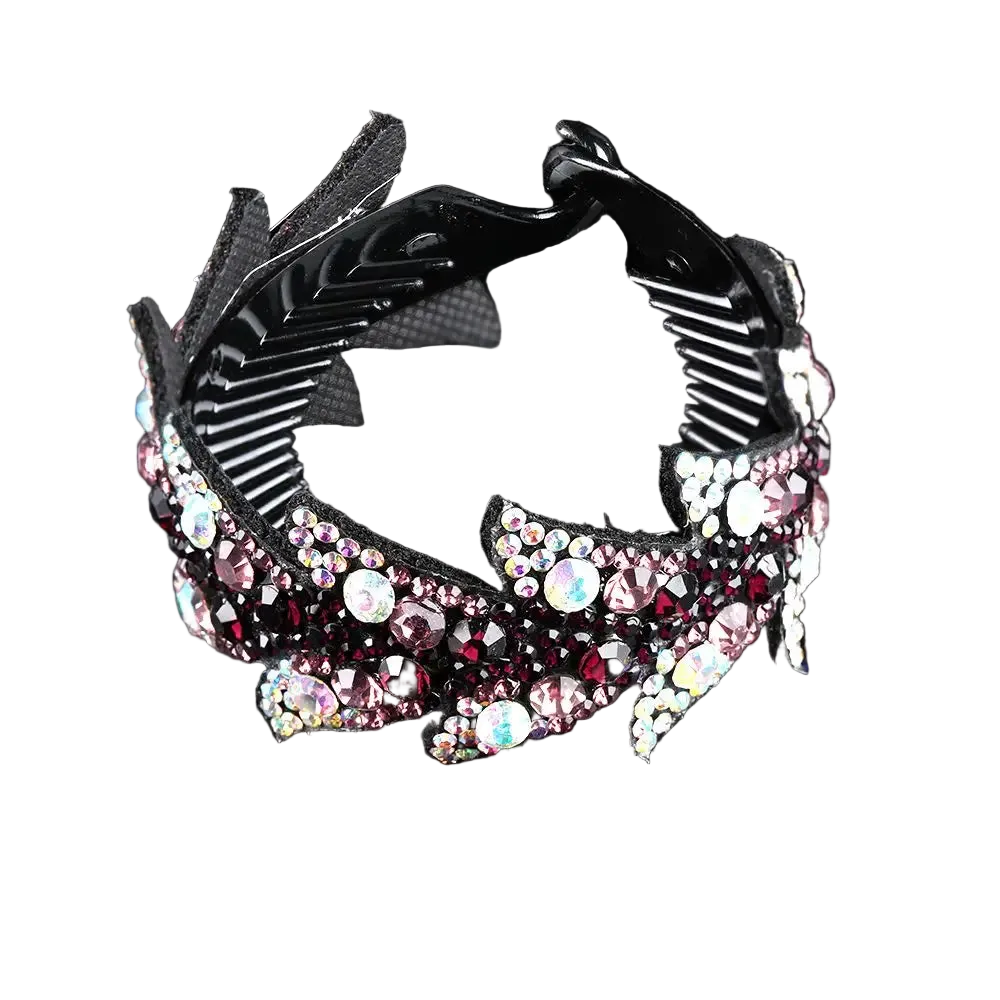A black claw-style hair clip embellished with pink, red, and iridescent rhinestones, shown on a reflective black background.