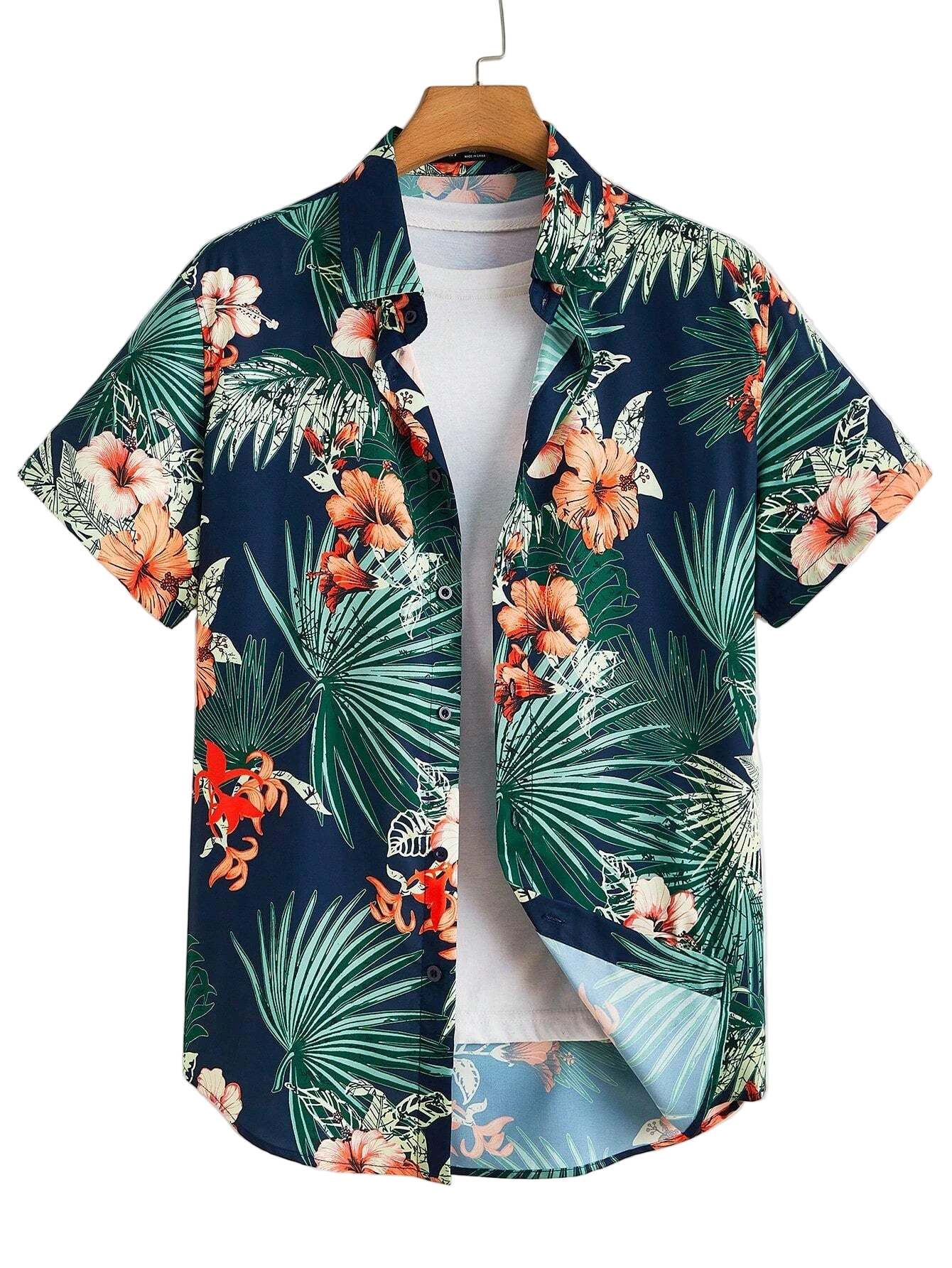 Hawaiian shirt with tropical leaf and flower pattern on a mannequin against a white background