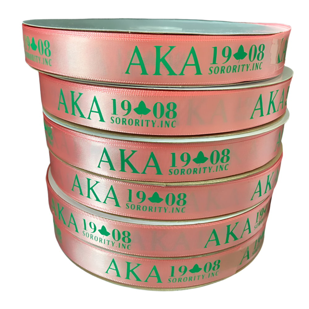 Stack of pink ribbons with green text 'AKA 1908 Sorority, Inc.' on a black background