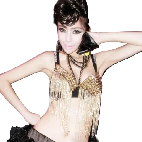 A woman modeling a black and gold fringed belly dance costume top with matching layered necklaces, posing against a dark gray background.