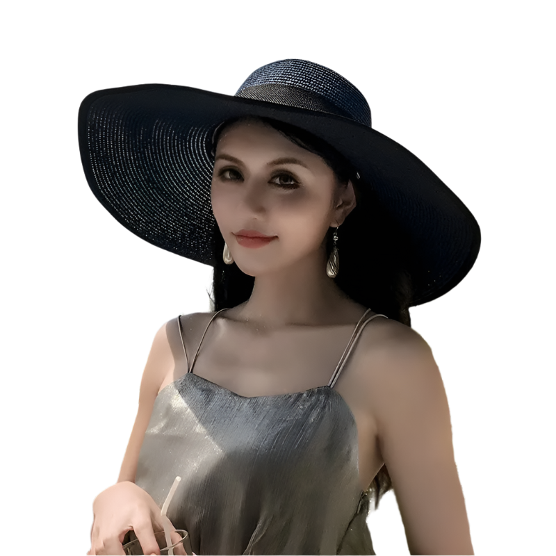 Woman wearing a black sun hat with a scenic background of ocean and sky.