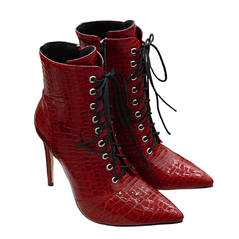 Red high-heeled boots with black laces on a white surface.