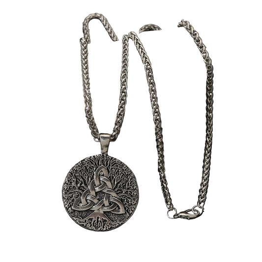 A silver Celtic knot pendant necklace with a triquetra design, displayed on a dark rock against a black reflective surface.