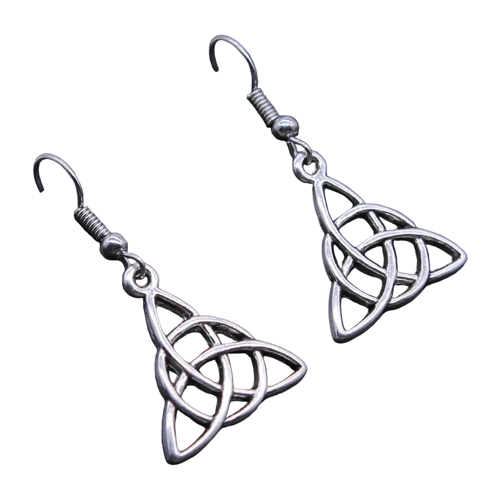 A pair of silver Celtic triquetra dangle earrings with fishhook backings, displayed on a dark textured surface.