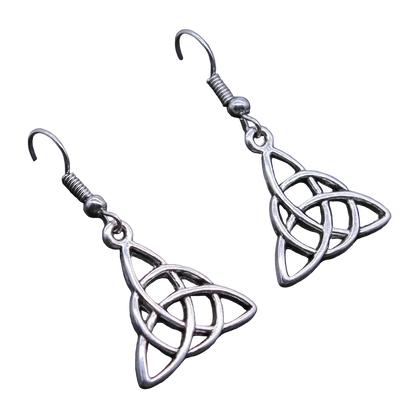 A pair of silver Celtic triquetra dangle earrings with fishhook backings, displayed on a dark textured surface.