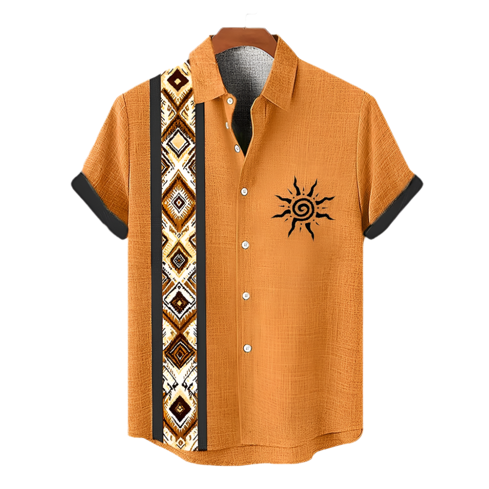 Orange shirt with black sun design and patterned side panel on a hanger against a white background.