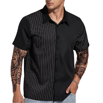 Man wearing a black short-sleeve shirt with white pinstripes on a plain background