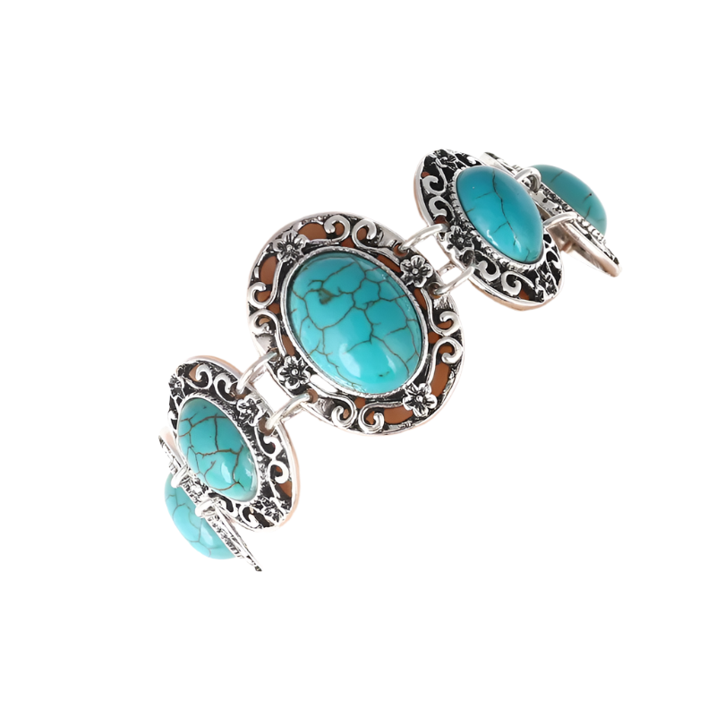 Turquoise stone bracelet with silver detailing on a mannequin arm