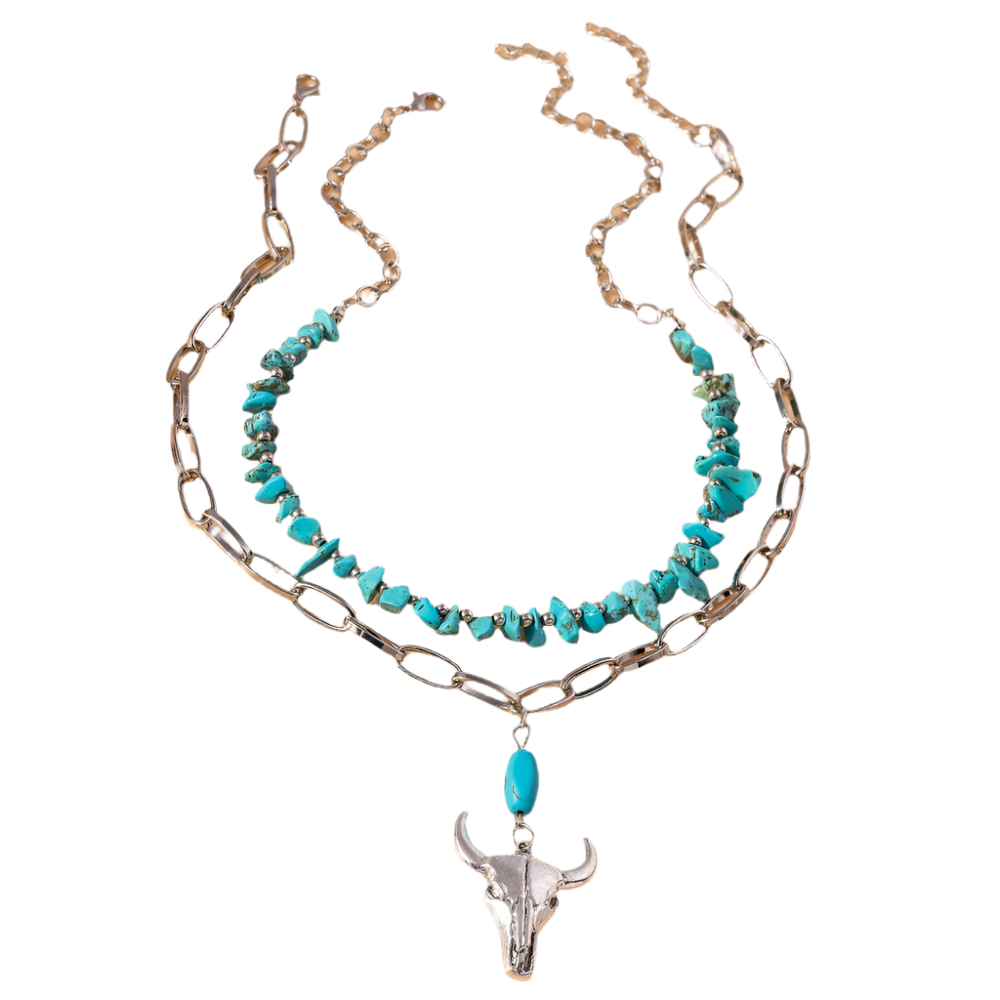 Necklace with turquoise stones and bull head pendant on a beige background