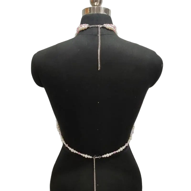 Pearl and chain body chain on a mannequin against a gray background