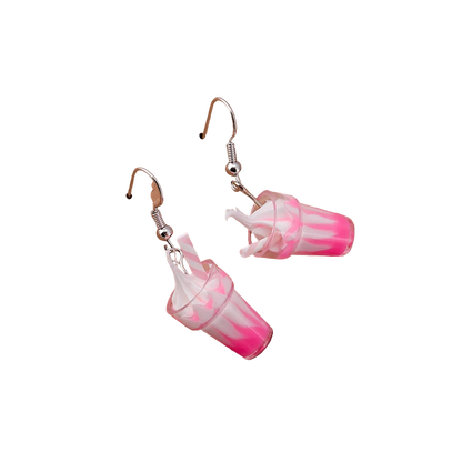 Pink and white cup earrings on a wooden block with 'Love Tea' text.