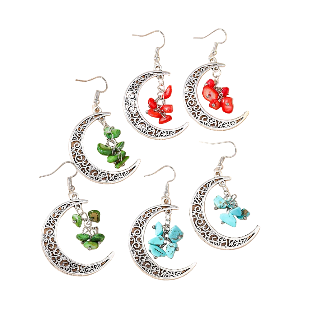 Set of moon-shaped earrings with floral and butterfly designs on a beige background