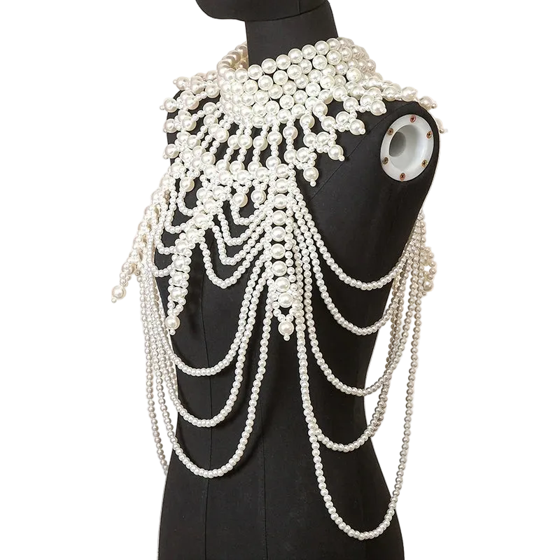 Mannequin wearing a decorative pearl shoulder piece against a neutral background