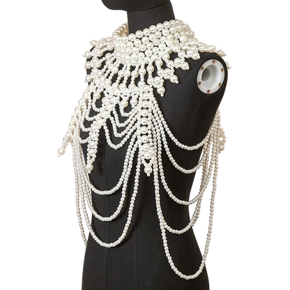Mannequin wearing a decorative pearl shoulder piece against a neutral background