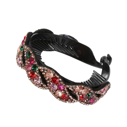 A black plastic hair comb embellished with a wavy border of pink, red, and green rhinestones on a white background.
