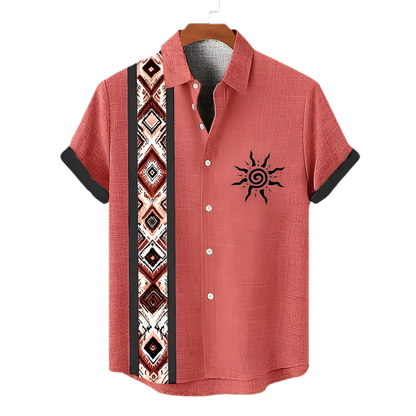 Red short-sleeve shirt with tribal pattern and sun design on a hanger against a white background.
