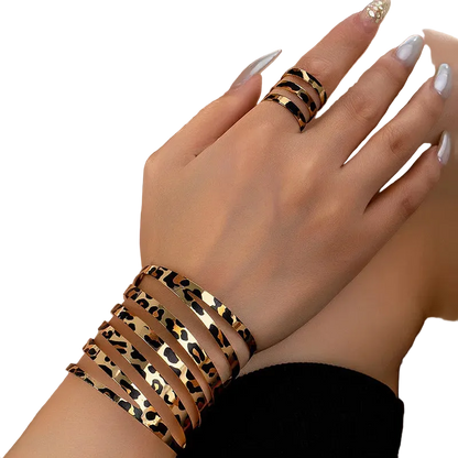 Leopard print bracelet and ring on a hand with a blurred background