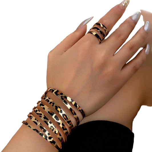 Leopard print bracelet and ring on a hand with a blurred background