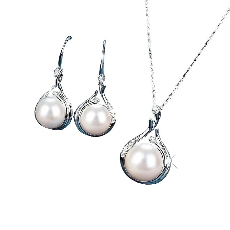 Silver-tone pearl jewelry set including a pendant necklace and matching drop earrings, displayed on a dark blue satin fabric background.