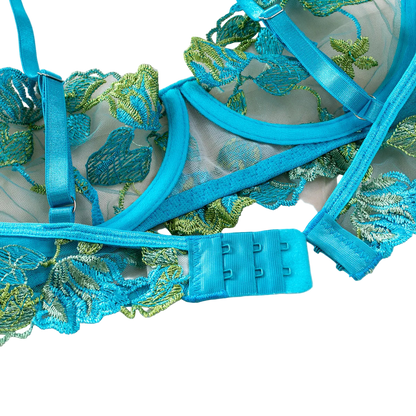 Blue lace lingerie set with floral embroidery on a white background