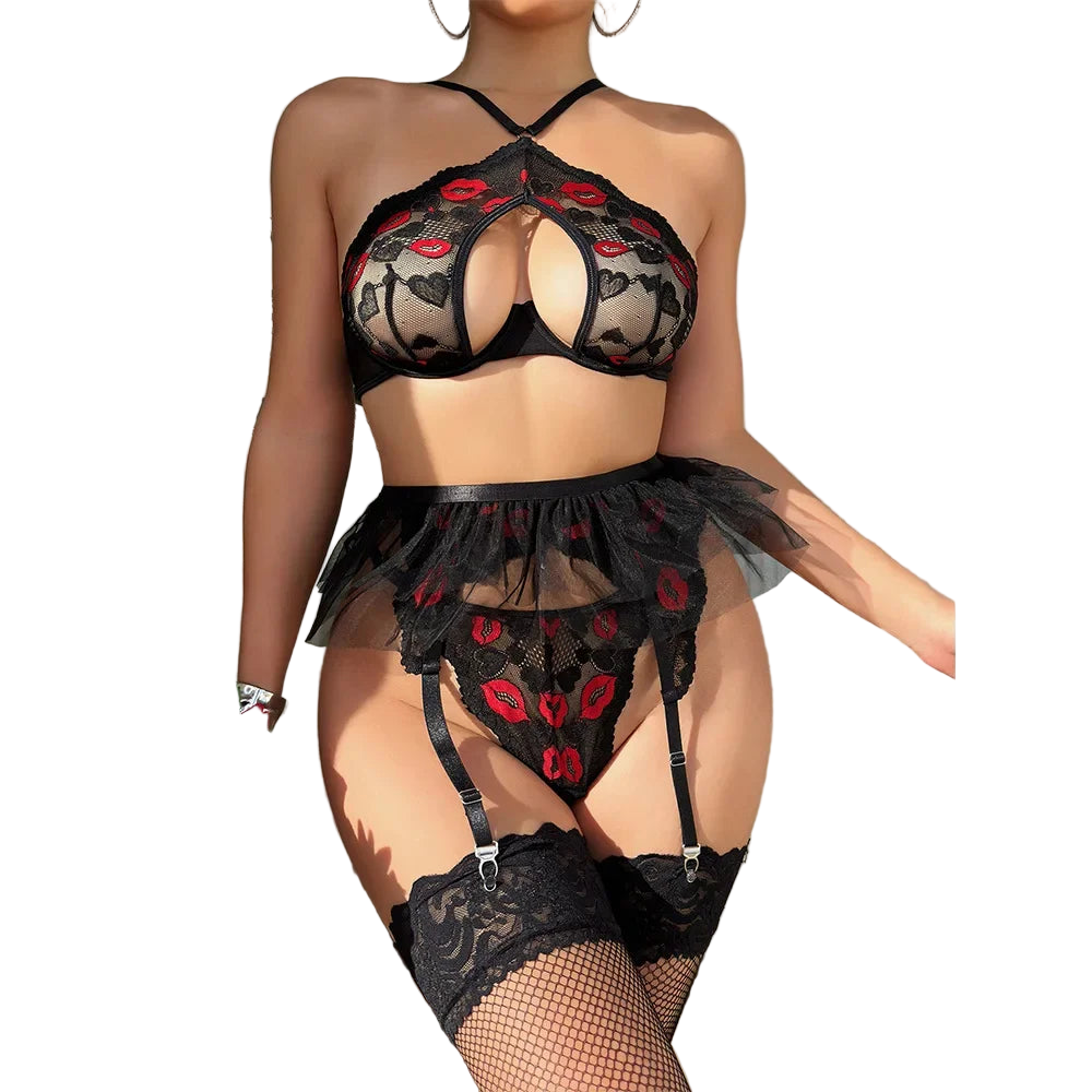 Person wearing a black lace lingerie set with red floral details, standing against a neutral background.