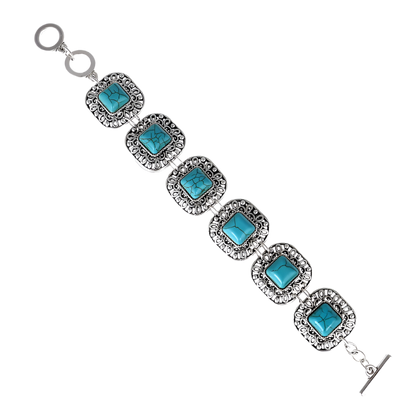 Turquoise stone bracelet with silver accents on a white background