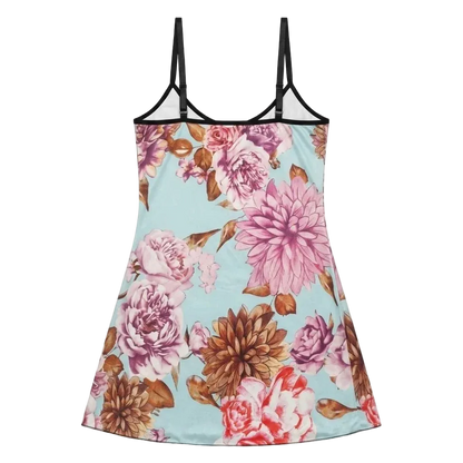 A sleeveless camisole-style nightgown with thin black shoulder straps and a light blue background covered in a large floral print featuring pink, mauve, and brown flowers.