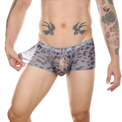 A close-up of a male model wearing low-rise boxer briefs with a gray and brown leopard print pattern, shown against a solid white background.