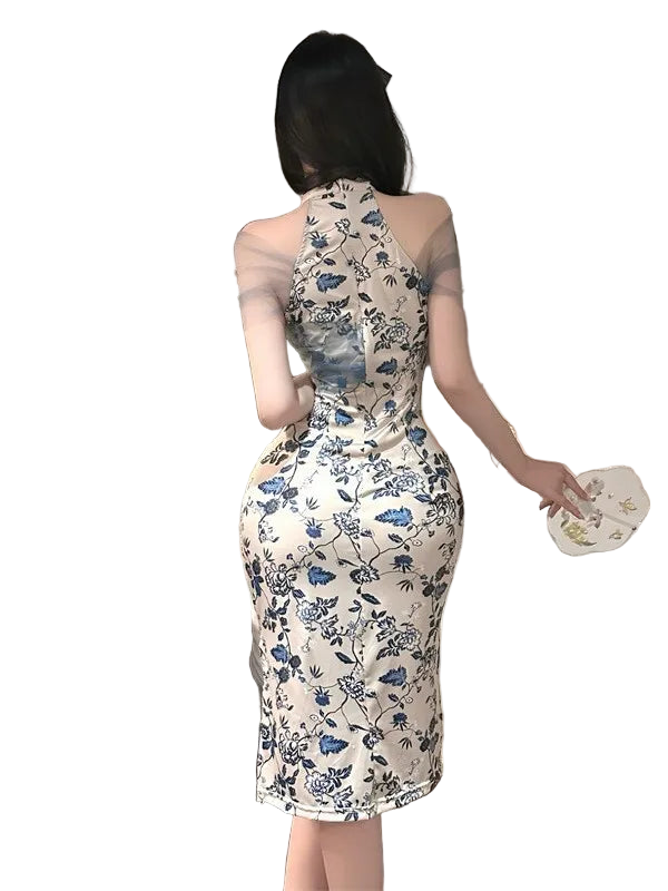 Woman in a floral dress standing in a bedroom