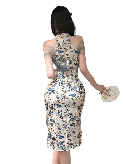 Woman in a floral dress standing in a bedroom