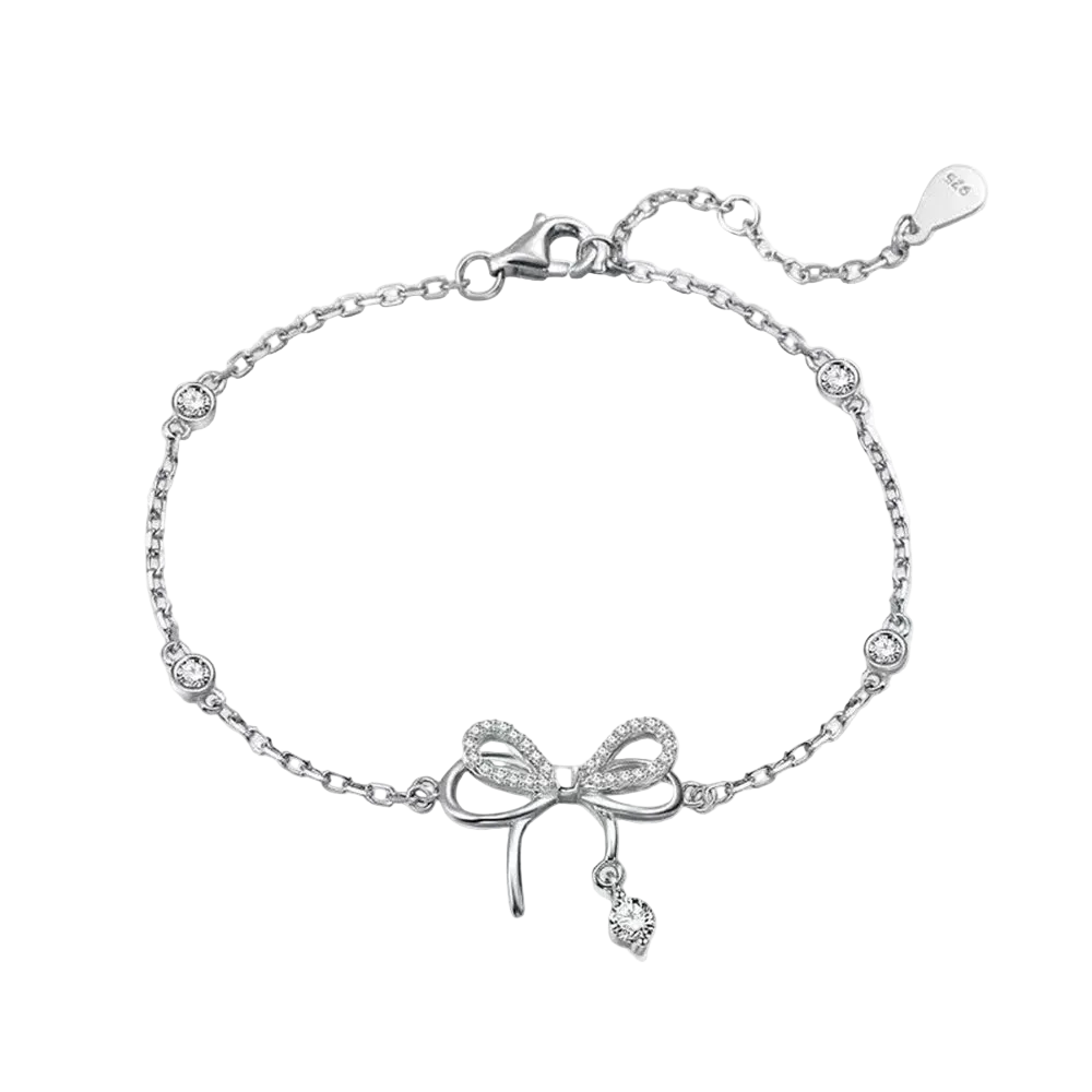 Silver bracelet with bow charm on a white background