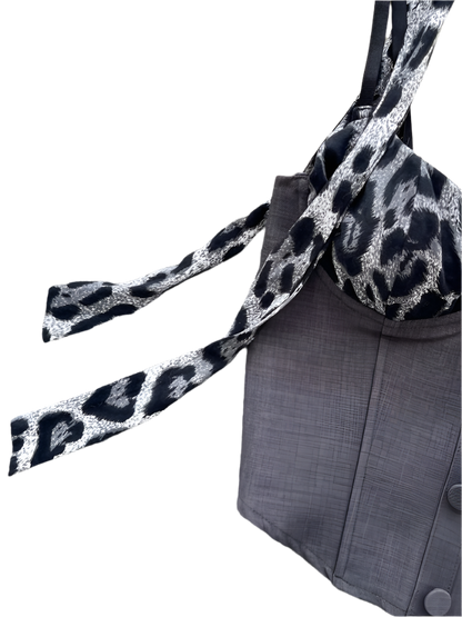 Gray coat with a leopard print scarf on a textured surface