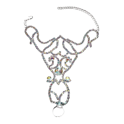 A silver-toned rhinestone belly chain with an intricate filigree design, a large central iridescent crystal, and a hanging ring, displayed on a dark reflective background.
